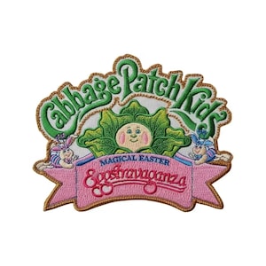 May include: Embroidered Cabbage Patch Kids patch with a green and gold border. The patch features the text "Cabbage Patch Kids" in green, a cabbage-like face, and the words "Magical Easter Eggstravaganza" on a pink banner.