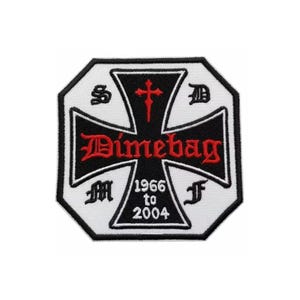 May include: A black and white patch with a red cross and the word "Dimebag" in red script. The patch has an octagonal shape with the years "1966 to 2004" and various symbols.