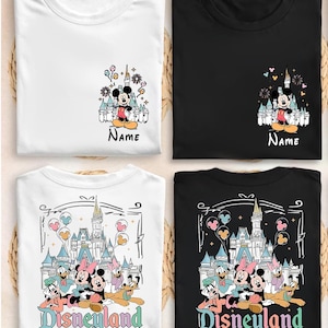 May include: Four t-shirts in white and black featuring Disney character graphics. Two shirts show Mickey Mouse with a castle and the text Name. Two shirts show Mickey, Minnie, Donald, Daisy, and Pluto with a castle and the text Disneyland Est. 1955.