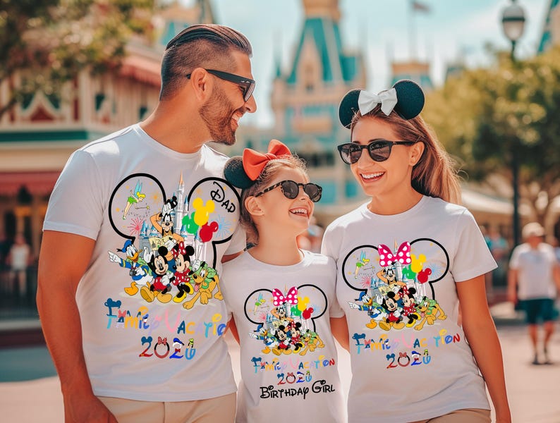 May include: Three white t-shirts featuring a large Mickey Mouse silhouette outline filled with colorful cartoon characters, including Mickey, Minnie, Donald, and Goofy. The text reads Family Vacation 2020, with Dad and Birthday Girl labels.