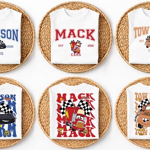 May include: Six white t-shirts featuring Disney Pixar Cars characters. The top row shows Jackson, Mack, and Tow Mater with names and EST 2006/2008. The bottom row displays larger, vibrant graphics of the same characters with checkered flags.