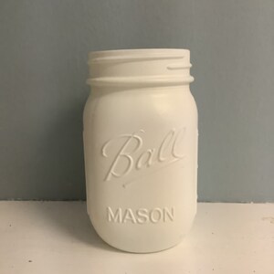 May include: White painted Ball Mason jar with the brand name and "MASON" embossed on the front.