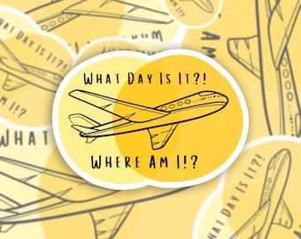 May include: A yellow sticker with a black outline of an airplane. The sticker has the text "WHAT DAY IS IT?!" and "WHERE AM I!?" in black. The background has a repeating pattern of airplane outlines.