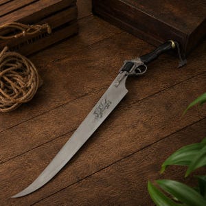 May include: A long, pointed metal blade attached to a revolver-style handle. The handle is black with a metallic trigger guard and cylinder. A small metal chain hangs from the end of the grip. The blade features an etched design on its surface.