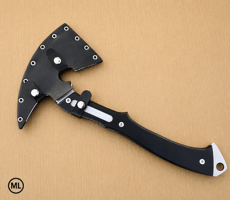 May include: A black hatchet with a curved blade encased in a matching black sheath. The sheath features silver-colored metal rivets along the edge and a snap closure. The handle is black with silver accents and a hole at the end for hanging.
