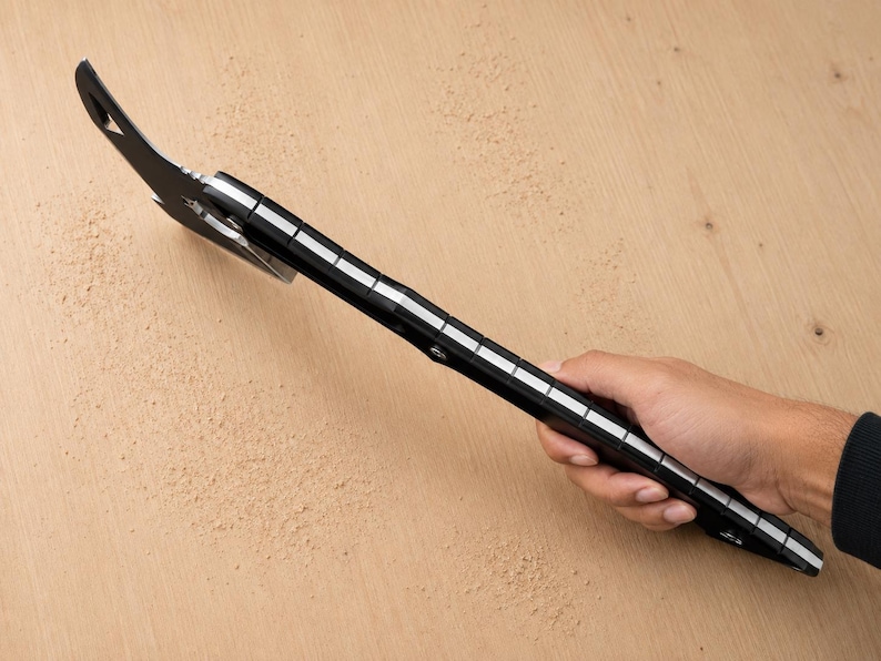May include: A black metal multi-tool pry bar featuring a flat, angled head with a nail-pulling slot and a long handle with integrated white measurement markings along the side, designed for leverage, prying, and various manual tasks.