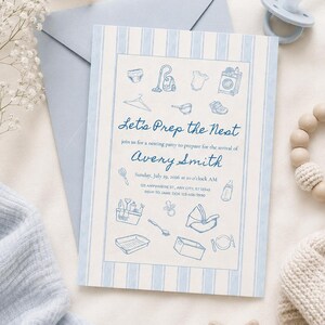May include: A rectangular invitation card with light blue vertical stripes featuring blue line-art illustrations of baby items and household objects. The text reads: Let's Prep the Nest, join us for a nesting party to prepare for the arrival of Avery Smith, Sunday, July 19, 2026 at o'clock AM, 123 Anywhere St., Any City, ST 12345, RSVP to Jane Doe 123-456-7890.