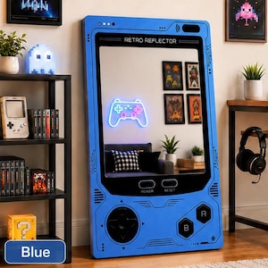 May include: A large blue floor mirror shaped like a vintage handheld gaming console. The frame features black directional buttons, A and B buttons, and labels for power and reset. The screen area displays a glowing neon white game controller.