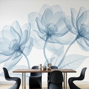 May include: A wall mural featuring large, translucent blue flowers with visible delicate veins and stamen details. The mural is displayed behind a rectangular wooden dining table with four black chairs and three small decorative ceramic objects.