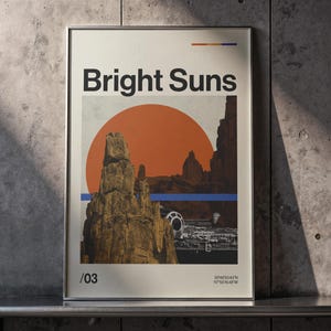 May include: A framed rectangular poster featuring the text Bright Suns at the top, a large orange sun behind rocky spires, a blue horizontal line, and a spacecraft silhouette. The bottom includes the text /03 and coordinates 33°48'53.43"N 117°55'16.48"W.