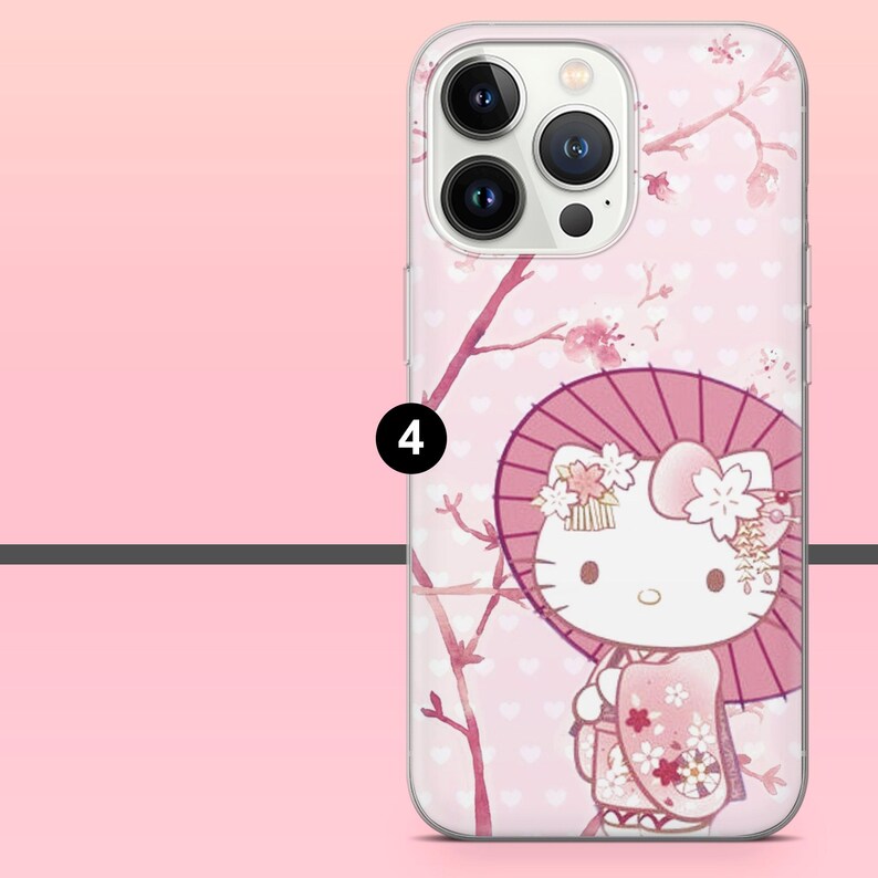 Puede incluir: Una funda de tel&eacute;fono rosa con un dise&ntilde;o de Hello Kitty con kimono sosteniendo un parasol. La funda tiene un patr&oacute;n floral y de coraz&oacute;n con ramas de flores de cerezo. La funda est&aacute; dise&ntilde;ada para un tel&eacute;fono inteligente.