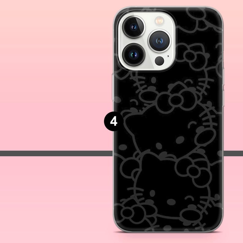 Puede incluir: Funda de tel&eacute;fono negra con un patr&oacute;n repetido de un gato de dibujos animados con un lazo. La funda tiene un borde transparente y cubre la parte trasera y los laterales del tel&eacute;fono. Las lentes de la c&aacute;mara del tel&eacute;fono son visibles.