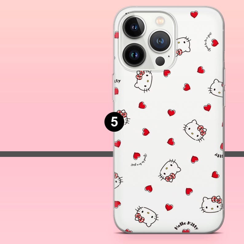 Puede incluir: Una funda blanca para tel&eacute;fono con un estampado de caras de Hello Kitty y corazones rojos. La funda tiene un borde transparente y un recorte para la c&aacute;mara. Las palabras "Hello Kitty" est&aacute;n impresas en la parte inferior.