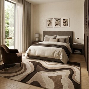 May include: A rectangular area rug featuring a layered, abstract topographic pattern in shades of dark brown, mocha, beige, and cream. The rug has a thick, textured pile with fluid, organic shapes that create a sense of depth and movement across the floor.