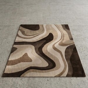 May include: A rectangular area rug featuring a fluid, abstract pattern of swirling organic shapes. The design consists of layered, wavy bands in varying shades of dark brown, medium brown, tan, and cream, creating a topographic effect.