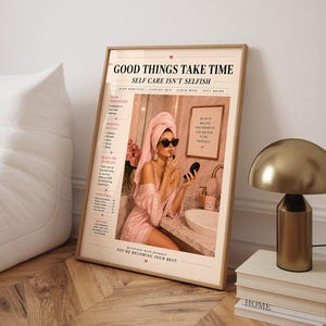 May include: A vertical poster featuring a magazine-style layout with the text GOOD THINGS TAKE TIME and SELF CARE ISN'T SELFISH. The image shows a person in a pink robe and hair towel applying makeup in a bathroom, with additional text and lists.
