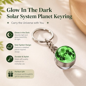 May include: A glow-in-the-dark solar system planet keyring featuring a spherical charm with a detailed green and black planetary surface, attached to a silver-toned metal split ring by a short chain, with text describing its features.
