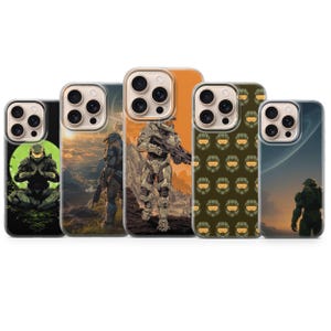 May include: Five smartphone cases featuring various Halo Master Chief graphics. Designs include a character meditating against a green circle, standing on a mountain, walking through a landscape, a repeating helmet pattern, and looking at a planet.