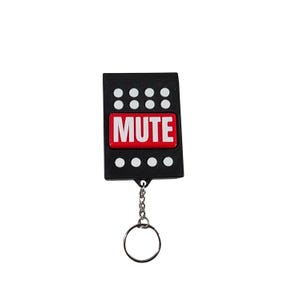 May include: A rectangular black keychain featuring a prominent red horizontal button in the center with the word MUTE printed in bold white capital letters. The black surface is decorated with eight small white circular dots arranged in two rows.
