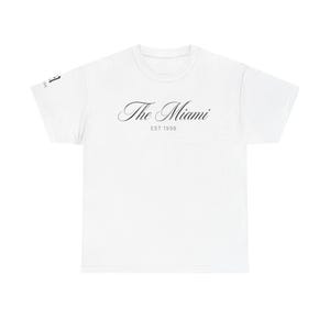 以下が含まれることがあります： 胸の中央に筆記体でThe MiamiとEST 1998という黒い文字がプリントされた白い半袖Tシャツ。右袖の端には1998という文字が入った小さな黒いグラフィックも確認できます。