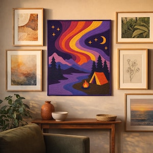 May include: A rectangular wall hanging quilt featuring a landscape scene with a dark purple sky, vibrant orange and yellow aurora borealis, a crescent moon, stars, dark pine trees, a winding river, a campfire, and an orange camping tent.