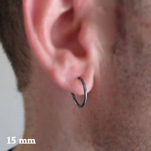 May include: A black hoop earring with a 15 mm diameter.