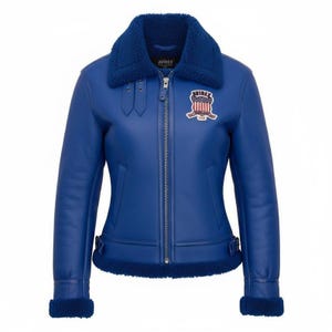 Back view of women’s blue Avirex USA genuine cowhide leather biker bomber jacket with bold lettering