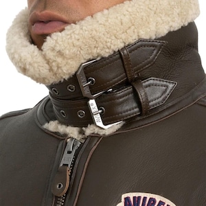 Close-up embroidered USA patch on brown leather shearling jacket