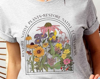May include: A gray t-shirt with a floral graphic and the text "Restore Native Plants - Restore Native Ecosystems".