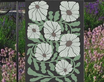 May include: A black garden flag with a white floral design. The flowers are stylized and have a green leafy background.