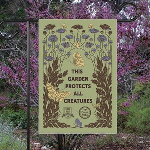 May include: A green garden flag with a brown floral design and the text "This garden protects all creatures". The flag also features a "Safe for Wildlife" logo and a "Pesticide Free" logo.