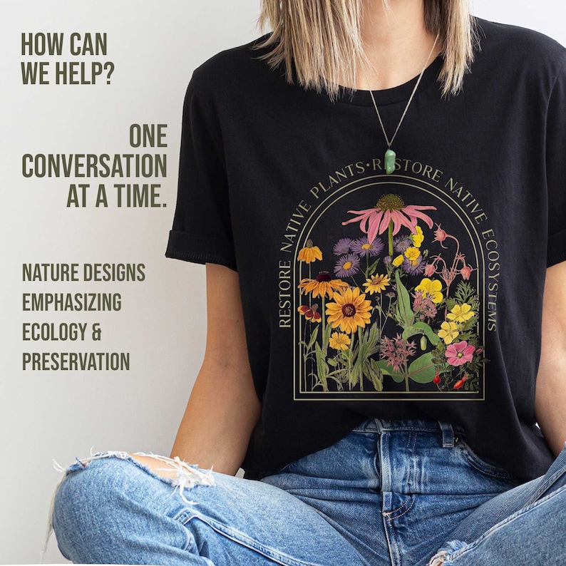 Black tee saying restore native plants. Image of a coneflower surrounded by many other wildflowers