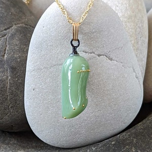 Monarch chrysalis glass necklace with 24k gold dots made by artist Jude Rose. www.juderose.com
