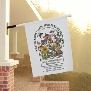 May include: A white flag featuring a colourful illustration of wildflowers within a window frame. The text reads "Restore Native Plants - Restore Native Ecosystems" and "This is a protected area for pollinators. We are sheltering and feeding our insect and bird friends in a pesticide and chemical-free zone."