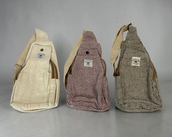 May include: Three hemp sling bags in cream, burgundy chevron, and gray tweed. Each bag has a zippered pocket, adjustable strap, and a small patch with a green leaf logo. The bags are designed to be worn across the body.