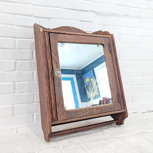 May include: A white ceramic mug with a black handle and the text "But First, Coffee" in a black, bold font. The mug is sitting on a white surface. The mug is approximately 4 inches tall.