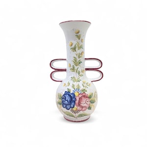 May include: A white ceramic vase with a bulbous base and a tall, slender neck. The vase has two loop handles and is decorated with hand-painted floral designs in blue, pink, and yellow. The rim and handles are trimmed in burgundy.