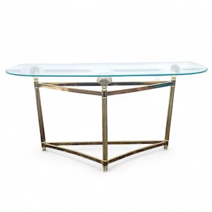 May include: A clear glass console table with a brass-colored metal frame. The table has a half-oval glass top and a geometric base. The table is approximately 48 inches long and 16 inches wide.