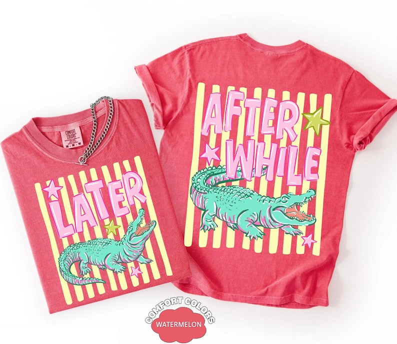 May include: Two red t-shirts with a graphic design featuring a teal alligator, pink text, and yellow stripes. One shirt says "LATER" and the other says "AFTER WHILE". The shirts are labeled "Comfort Colors Watermelon".