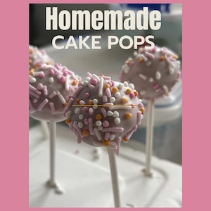 May include: Several round cake pops coated in a light purple icing and decorated with white, pink, and orange sprinkles. Each cake pop is mounted on a thin white stick. The text "Homemade CAKE POPS" is displayed in white at the top of the image.