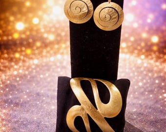 These are Shiana handmade gold vermeil swirl earrings with a brushed finish and bracelet