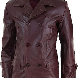 May include: A double-breasted burgundy leather jacket featuring a wide notched collar, six front buttons, two side pockets with flaps, and adjustable buttoned cuffs. The jacket has a smooth finish and a structured design with visible stitching details.