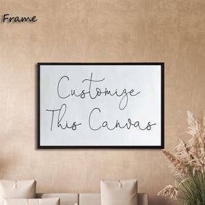 May include: A rectangular canvas print enclosed in a thin black frame. The white canvas features the black cursive text "Customize This Canvas" centred on the surface. The artwork is displayed horizontally, showcasing a clean and simple design.