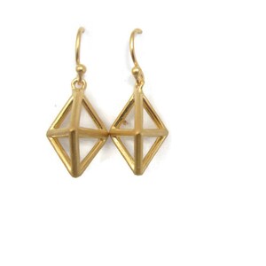 May include: A pair of gold-toned geometric dangle earrings with a diamond-shaped design.