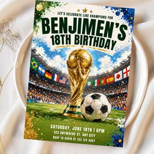 May include: A rectangular birthday invitation card featuring a gold trophy and a soccer ball on a green field inside a stadium. The text reads: LET'S CELEBRATE LIKE CHAMPIONS FOR BENJIMEN'S 18TH BIRTHDAY, SATURDAY, JUNE 18TH | 6PM, 123 ANYWHERE ST, ANY CITY, RSVP TO DAVID AT 123 123 4567.