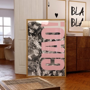 May include: A rectangular wall art print in a light wood frame featuring a black and white photograph of multiple disco balls. The word CIAO! is printed in large, bold, light pink capital letters vertically across the centre of the image.