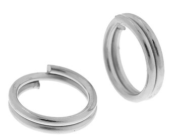 May include: Two silver-toned metal key rings. The key rings are double-looped and have a smooth, polished finish.