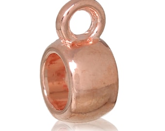 May include: Rose gold-toned metal bead with a small loop at the top. The bead has a smooth, rounded surface.