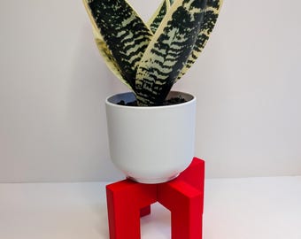 Soporte para plantas de resina acrílica roja, decoración moderna basada en la teoría del color.