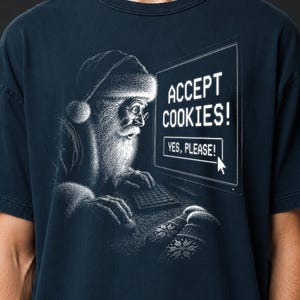 May include: A dark navy blue t-shirt featuring a white graphic of Santa Claus wearing glasses and a hat while using a computer. The screen displays the text ACCEPT COOKIES! and a button labeled YES, PLEASE! with a mouse cursor pointing at it.